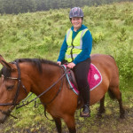 Girl in green jumper on brown horse in County Antrim