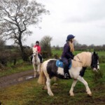 2 girls walking off trail onto field in County Antrim