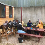 girls cleaning horse saddles in County Antrim