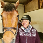 Old woman smiling beside horse in County Antrim